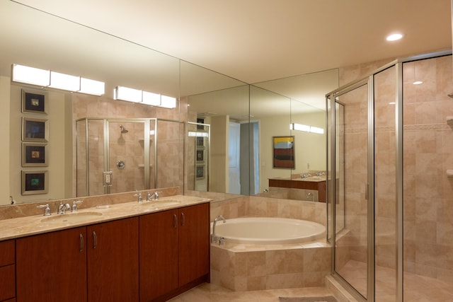 bathroom featuring vanity and separate shower and tub