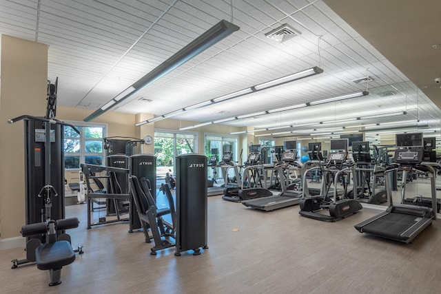 workout area with hardwood / wood-style floors