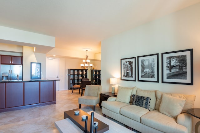 living room with light tile patterned flooring and a chandelier