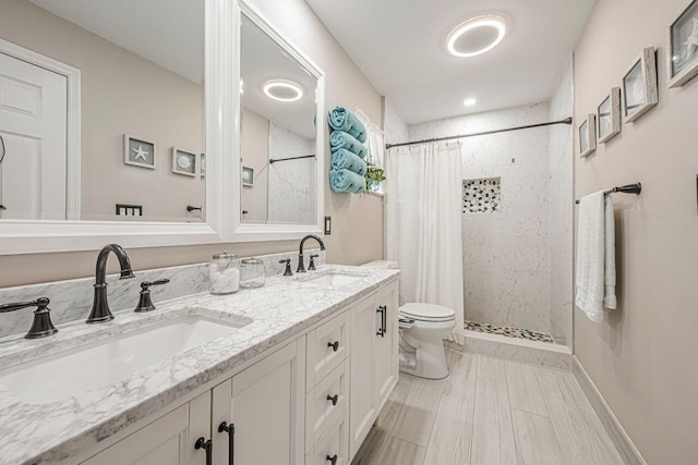 bathroom with vanity, curtained shower, and toilet