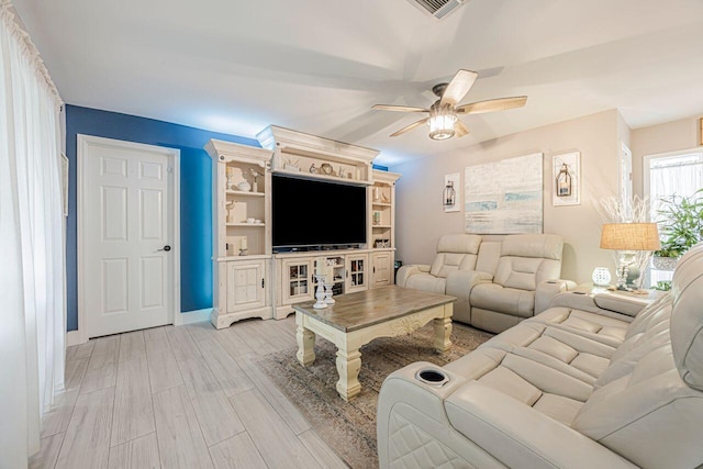 living room featuring light wood-type flooring and ceiling fan