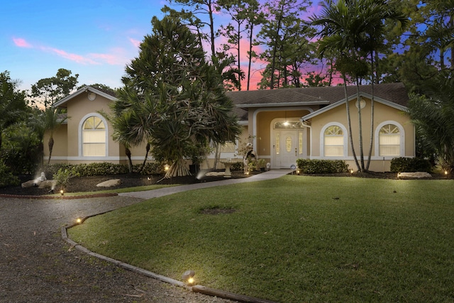 view of front of house with a yard