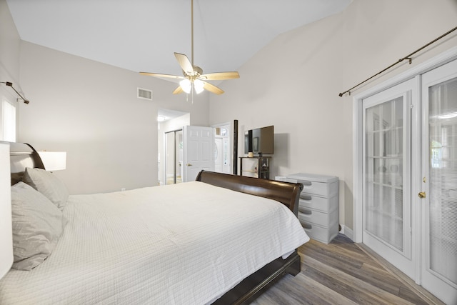 bedroom with wood finished floors, high vaulted ceiling, baseboards, ceiling fan, and access to exterior