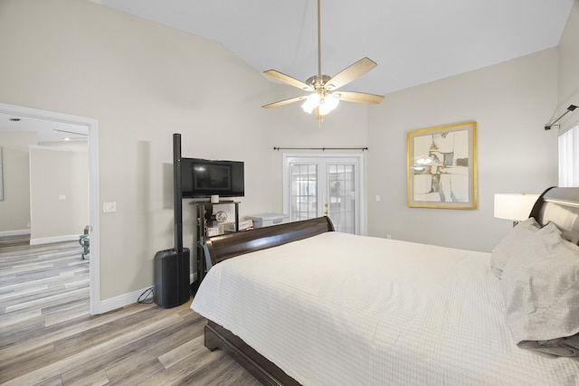 bedroom with ceiling fan, access to exterior, vaulted ceiling, light hardwood / wood-style flooring, and french doors