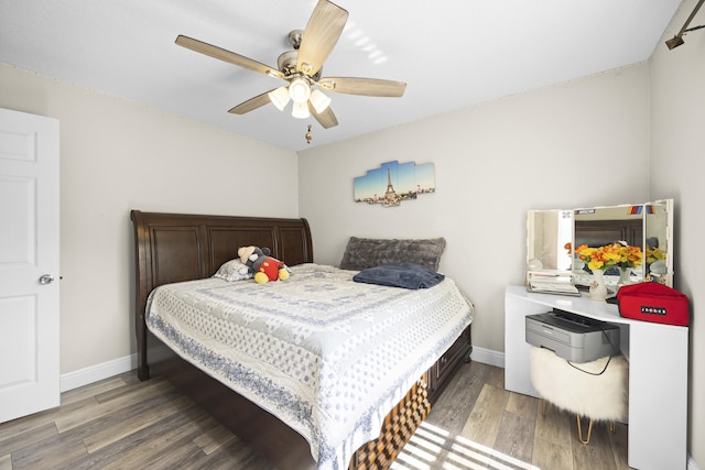 bedroom with hardwood / wood-style floors and ceiling fan