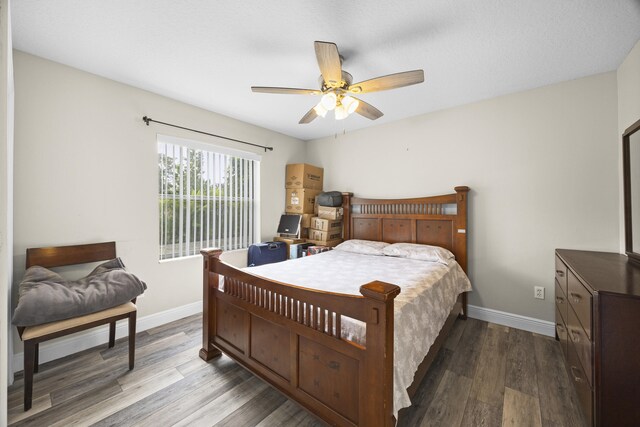 bedroom with wood-type flooring and ceiling fan