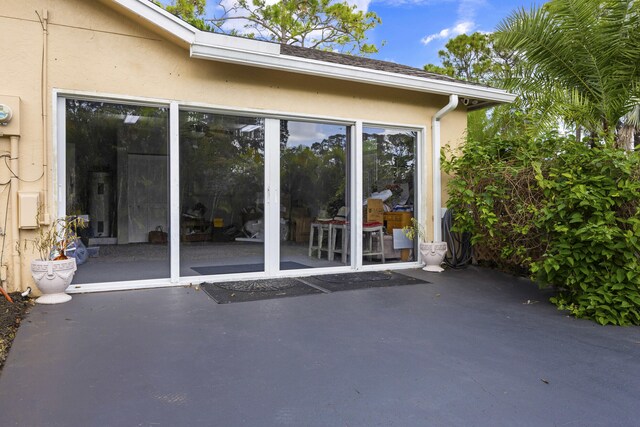 5481 Royal Palm Beach Blvd, West Palm Beach, FL 33411 - doorway to property featuring stucco siding and a patio