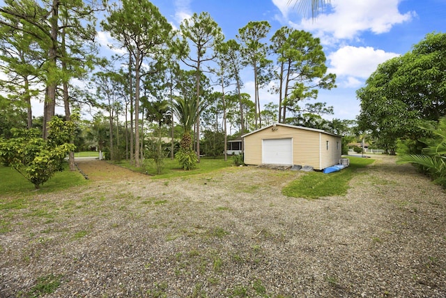 view of yard with an outbuilding and a garage