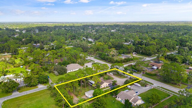 5481 Royal Palm Beach Blvd, West Palm Beach, FL 33411 - aerial view of property and surrounding area with property parcel outlined and a heavily wooded area