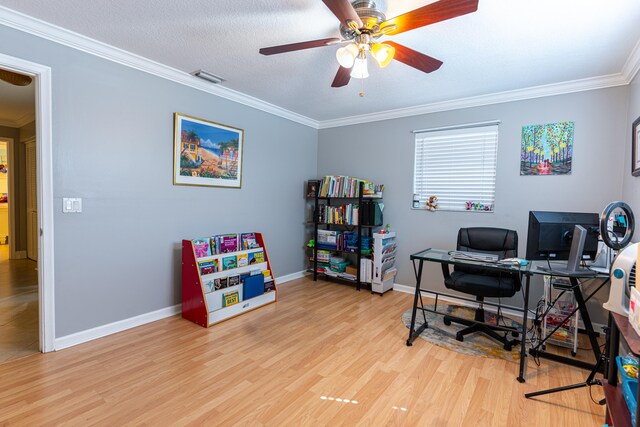 office featuring ceiling fan, ornamental molding, a textured ceiling, and light wood-type flooring