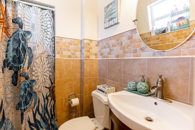 bathroom with vanity, tile walls, a shower with curtain, and toilet