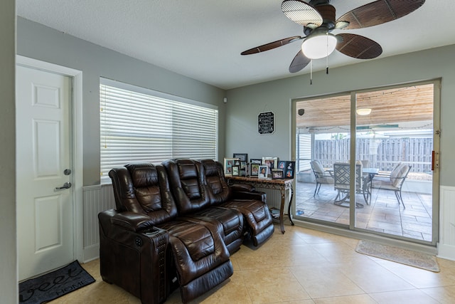 tiled living room featuring a wealth of natural light, a textured ceiling, and ceiling fan