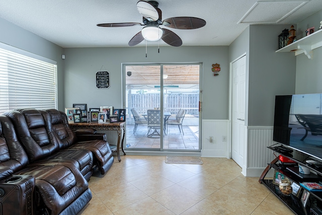 living room with a textured ceiling, plenty of natural light, and ceiling fan