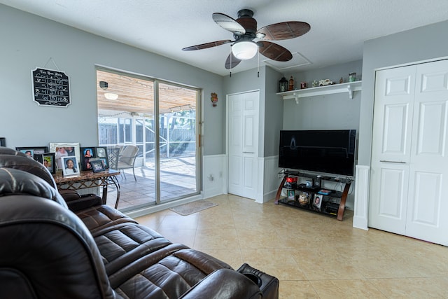 tiled living room featuring ceiling fan and a textured ceiling