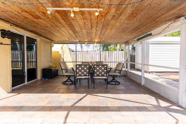 sunroom / solarium featuring wood ceiling