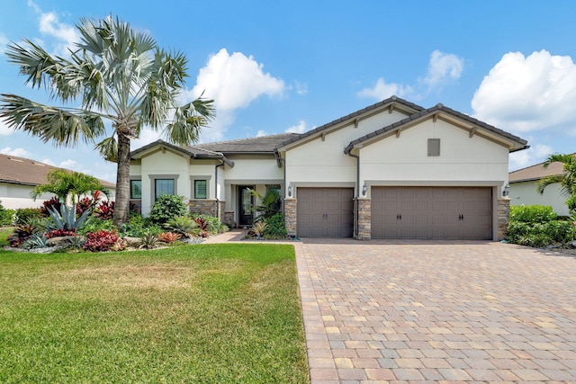 view of front of home with a front lawn and a garage