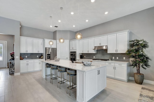 kitchen featuring appliances with stainless steel finishes and white cabinets