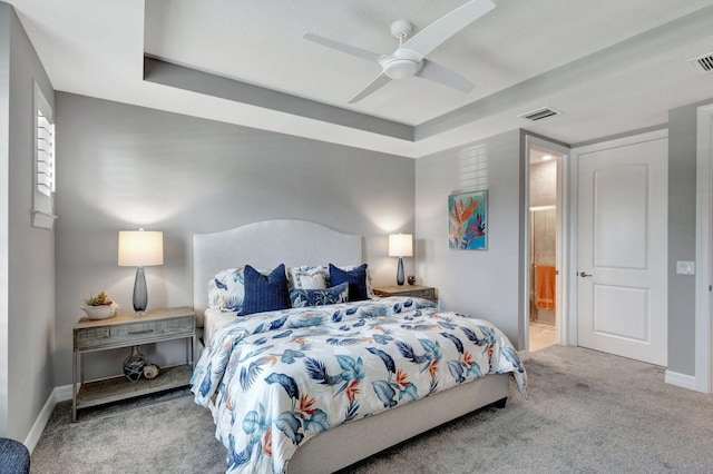 bedroom featuring carpet flooring, ensuite bathroom, and ceiling fan