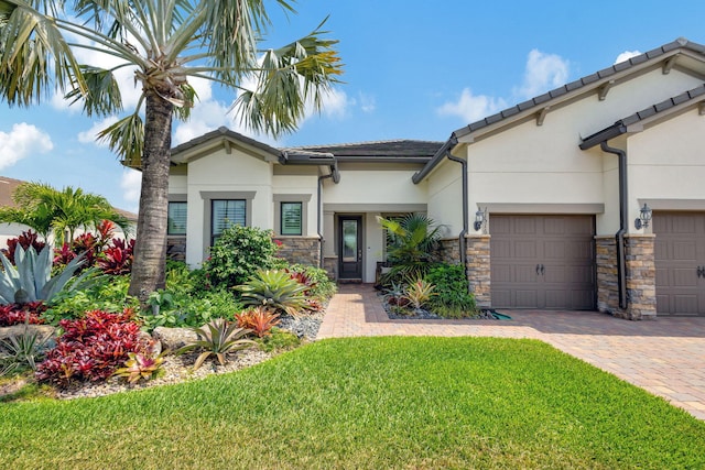 view of front of house with a front lawn and a garage