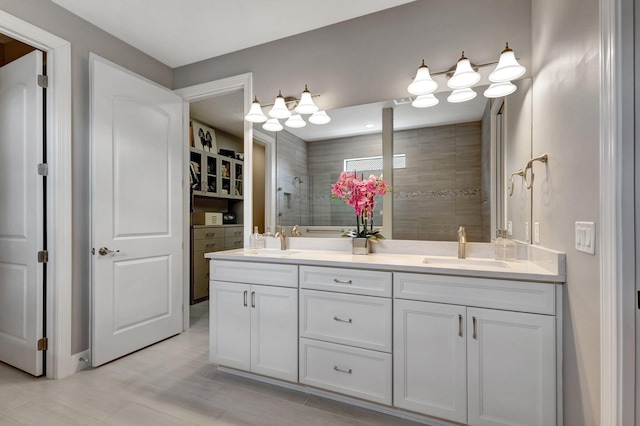 bathroom featuring vanity and tiled shower