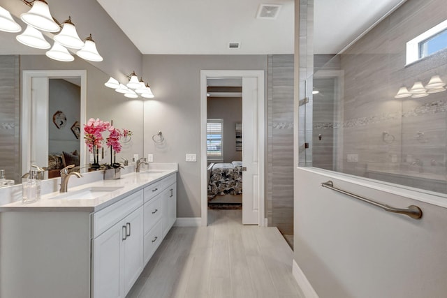 bathroom featuring vanity and a tile shower