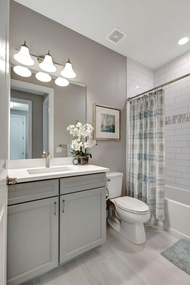 full bathroom featuring vanity, toilet, tile patterned floors, and shower / tub combo with curtain