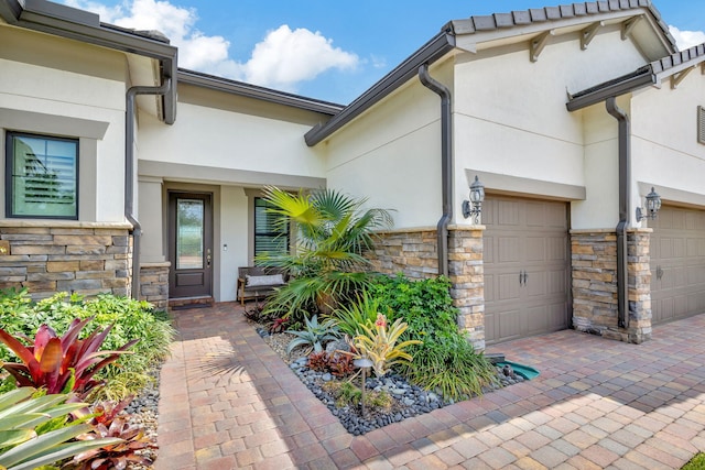 doorway to property with a garage