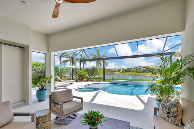 view of swimming pool featuring a water view, a patio, a lanai, and ceiling fan