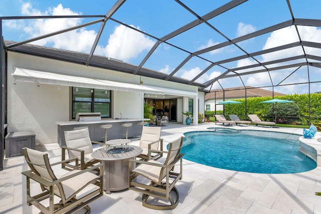 view of pool with pool water feature, a patio area, and a lanai