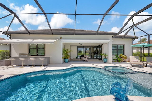 view of swimming pool with a patio area, a lanai, and an in ground hot tub