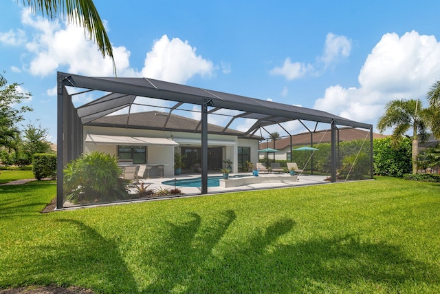 back of property featuring a patio area, a yard, and glass enclosure