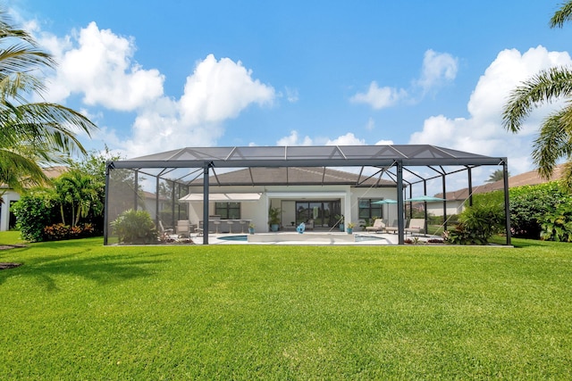 back of property featuring a patio area, a lawn, and glass enclosure