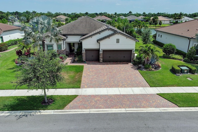 view of front of home featuring a garage and a front lawn