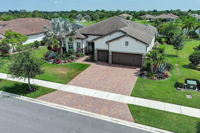 view of front of property with a front lawn and a garage