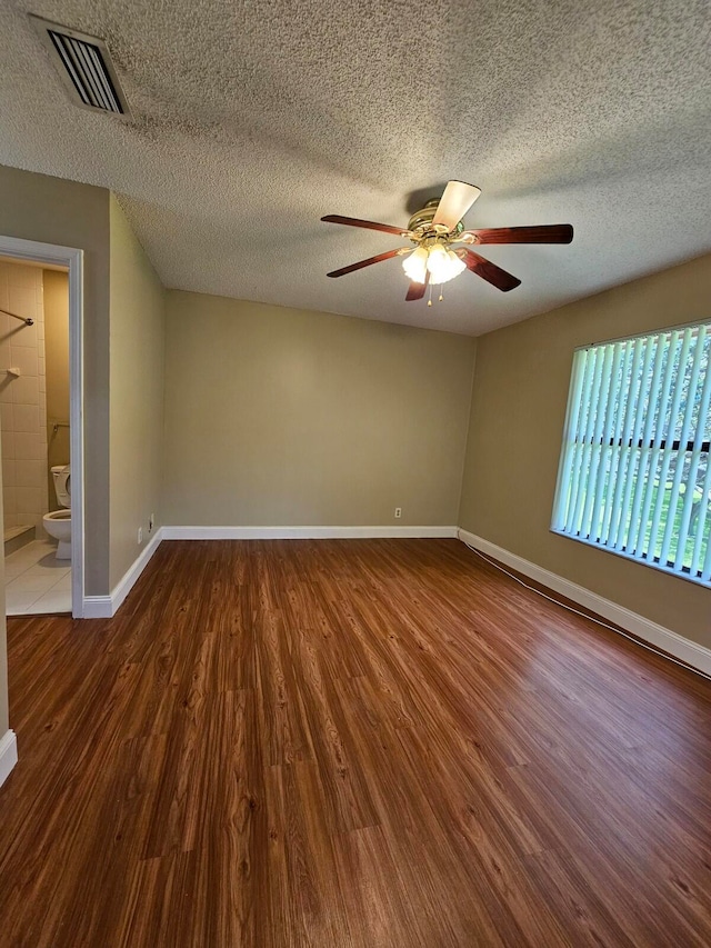 unfurnished room with a textured ceiling, hardwood / wood-style flooring, and ceiling fan