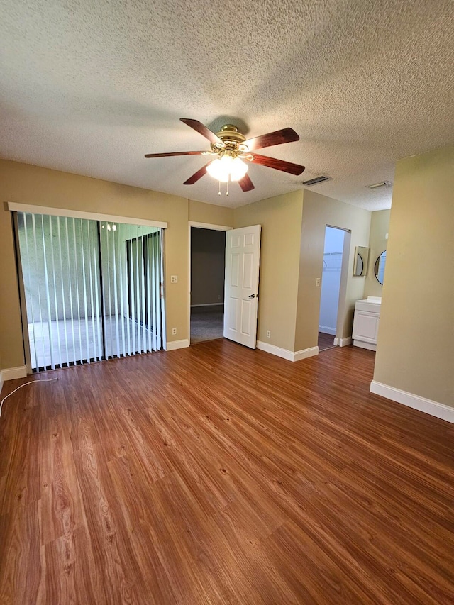 spare room with a textured ceiling, hardwood / wood-style flooring, and ceiling fan