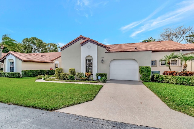 mediterranean / spanish house with a garage and a front lawn