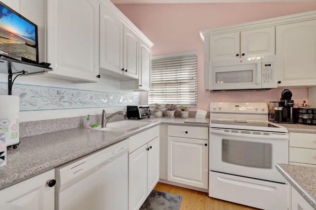 kitchen featuring sink, white cabinetry, white appliances, and light hardwood / wood-style floors