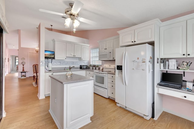 kitchen featuring lofted ceiling, light hardwood / wood-style flooring, a center island, white cabinetry, and white appliances