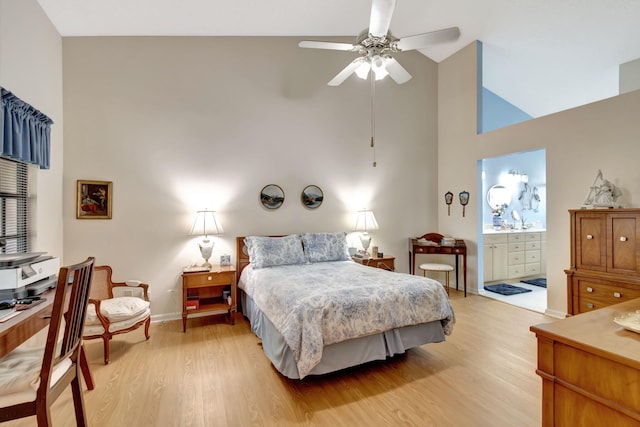 bedroom with light hardwood / wood-style floors, ensuite bath, high vaulted ceiling, and ceiling fan