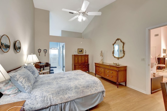 bedroom featuring connected bathroom, light hardwood / wood-style flooring, high vaulted ceiling, and ceiling fan