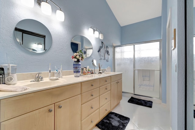 bathroom with vanity, lofted ceiling, and tile patterned floors