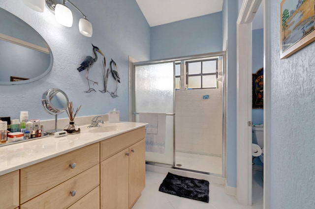 bathroom featuring vanity, a shower with shower door, toilet, and tile patterned flooring