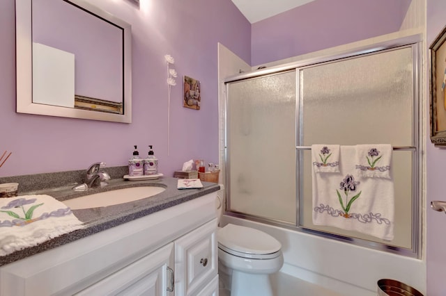 full bathroom with vanity, toilet, and enclosed tub / shower combo