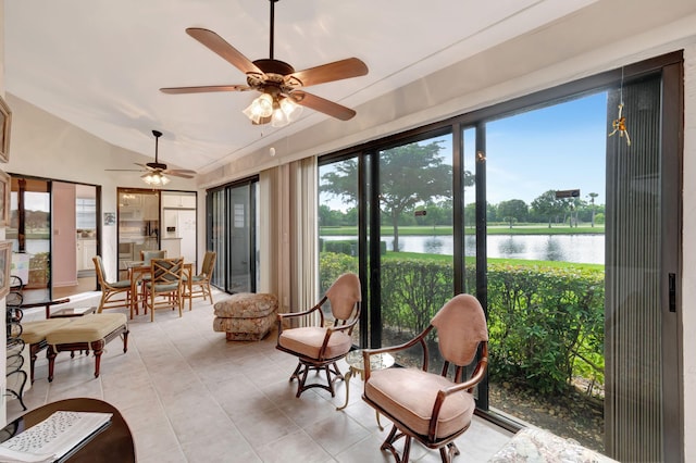 sunroom with a water view, ceiling fan, lofted ceiling, and a wealth of natural light