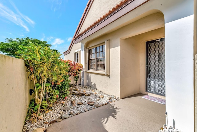 8282 Mooring Cir, Boynton Beach, FL 33472 - property entrance featuring stucco siding and a tiled roof