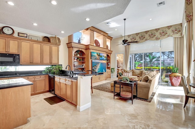 kitchen with kitchen peninsula, ceiling fan, a textured ceiling, pendant lighting, and sink