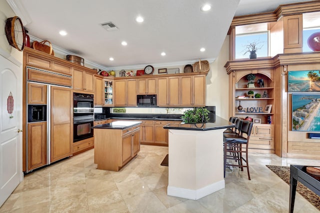 kitchen with black appliances, a center island, a kitchen bar, and ornamental molding