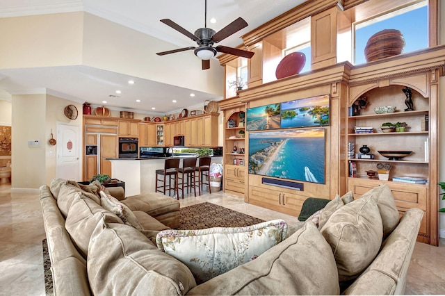 tiled living room featuring ornamental molding, a high ceiling, and ceiling fan