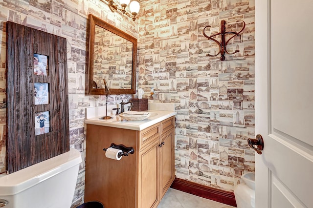 bathroom featuring toilet, vanity, and tile patterned flooring